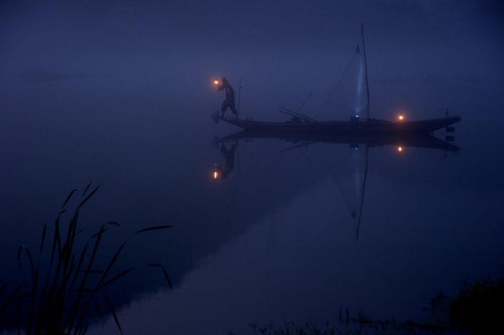 Photo of long boat at night